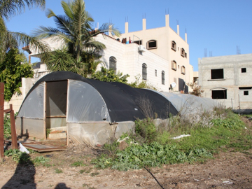 The family of the yellow three story house are prohibited from using the top floor and roof of their house. Their home which overlooks the Wall surrounding Qalqiliya was regularly opened to visiting delegations so that they get a more visual grasp of the impact of the Wall on the village. The Israeli military have issued an order permitting the army to shoot anyone who is seen on the roof or top floor on sight. This significantly violates the family's rights to life, freedom of movement, property and privacy.